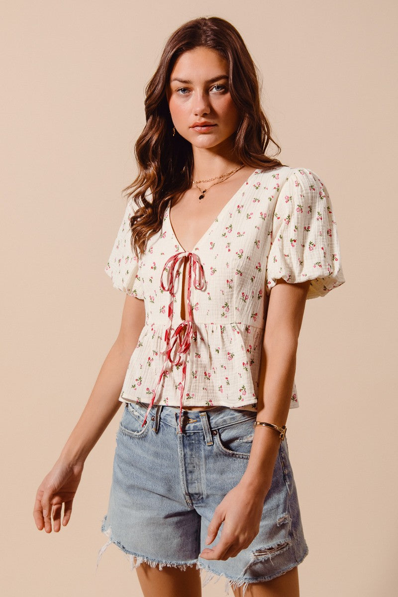 Ivory and red ditsy floral print gauze tie-front blouse by Trendsi, featuring a lightweight, breathable fabric with a feminine design.