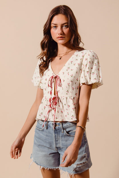 Ivory and red ditsy floral print gauze tie-front blouse by Trendsi, featuring a lightweight, breathable fabric with a feminine design.