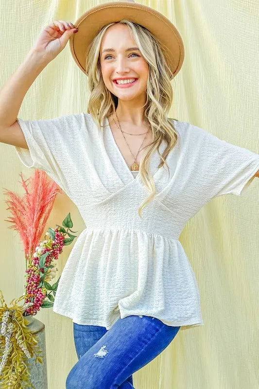 Ivory textured and soft V-neck casual top by Trendsi, featuring a relaxed fit and stylish design.