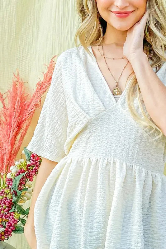 Ivory textured and soft V-neck casual top by Trendsi, featuring a relaxed fit and comfortable fabric for everyday wear.