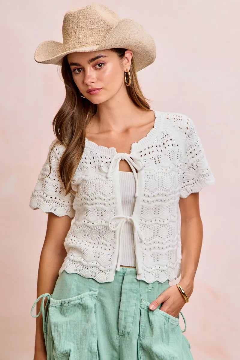Ivory Trendsi BiBi front bow tie detail pointelle knit top, close-up of the lightweight, textured sweater with bow accents.