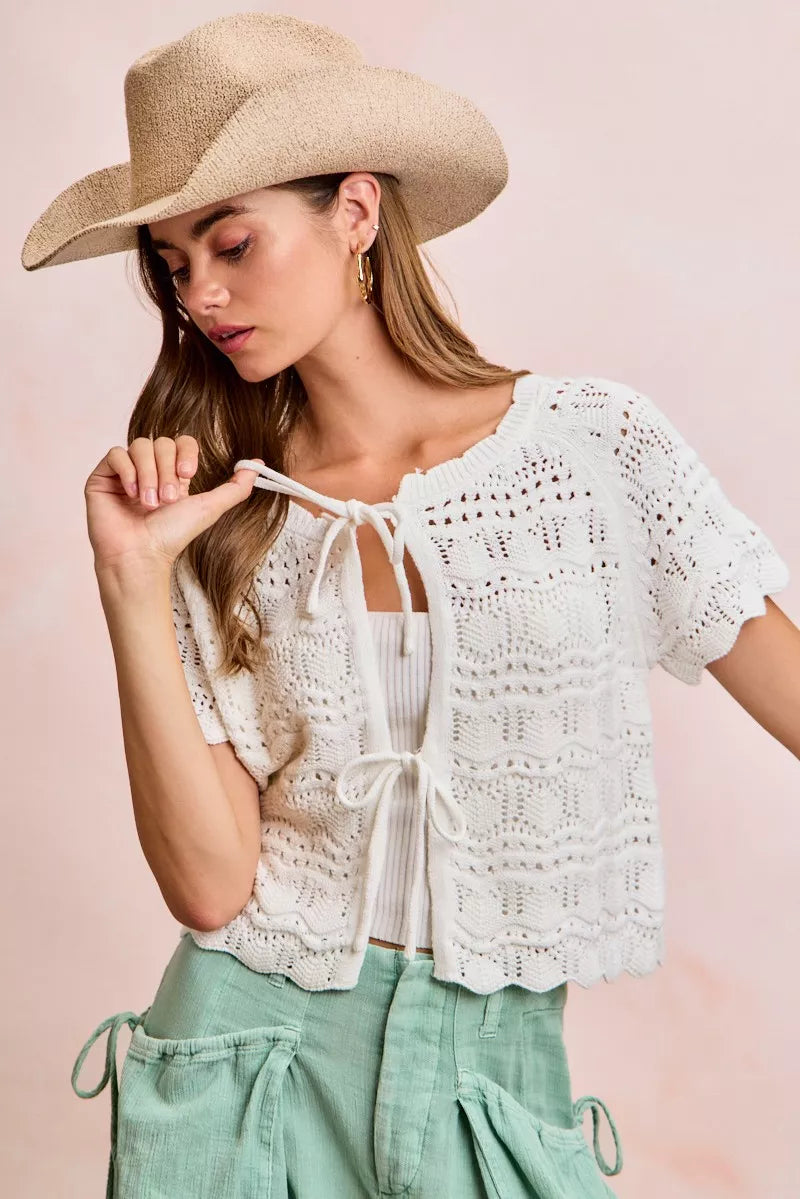 Ivory pointelle knit top by Trendsi featuring a front bow tie detail and a fitted, stylish design.