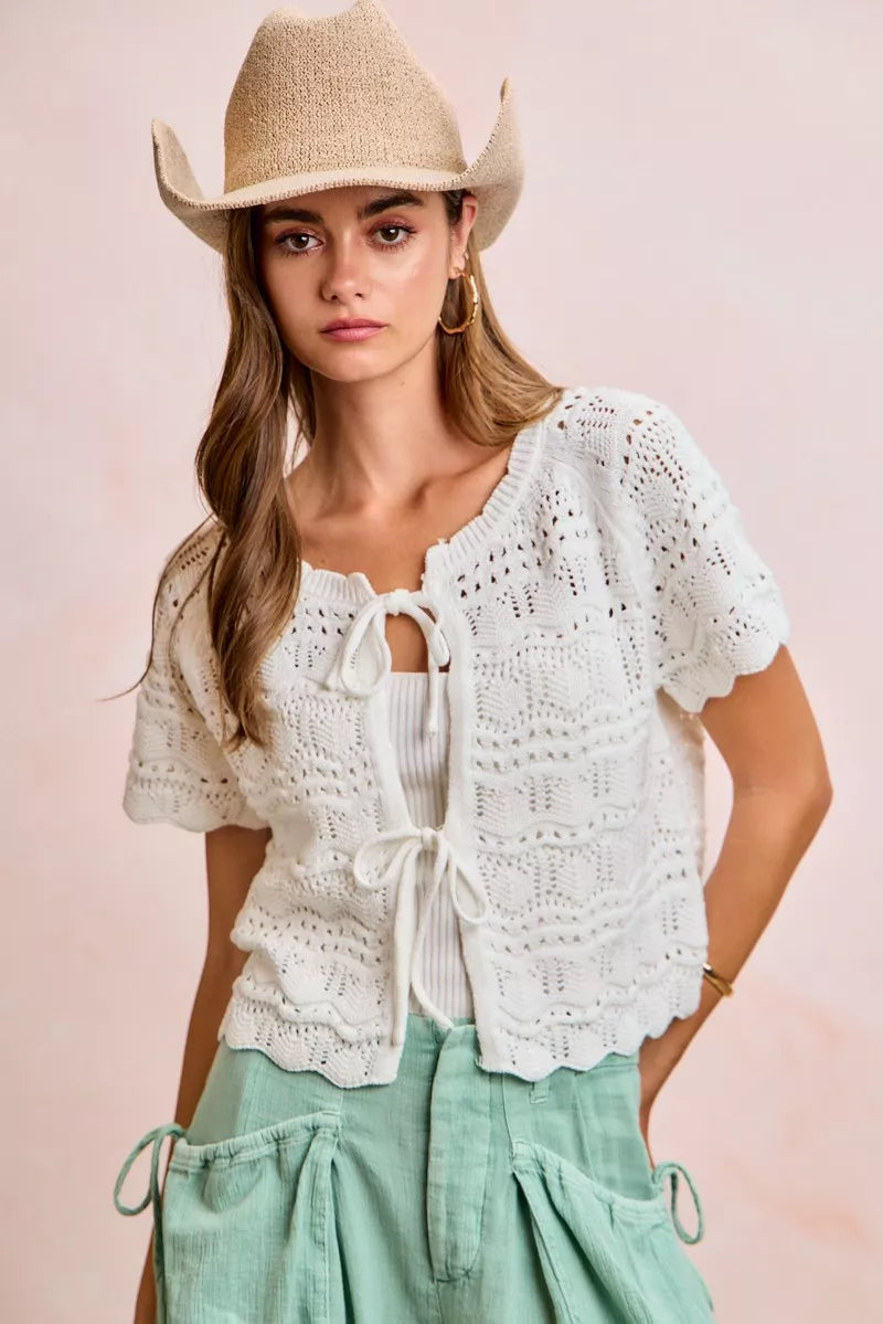 Ivory pointelle knit top with front bow tie detail and long sleeves, by Trendsi, featuring a stylish, feminine design.