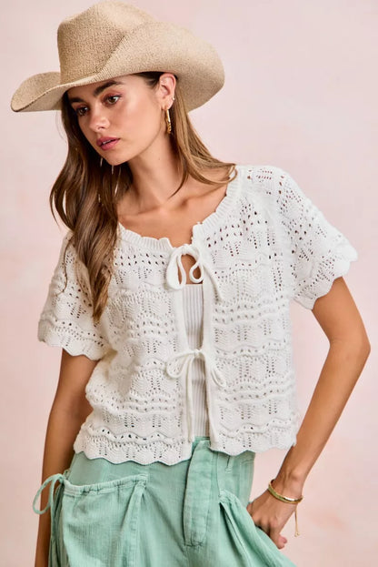 Ivory BiBi front bow tie detail pointelle knit top by Trendsi, showing the feminine design and delicate knit pattern.