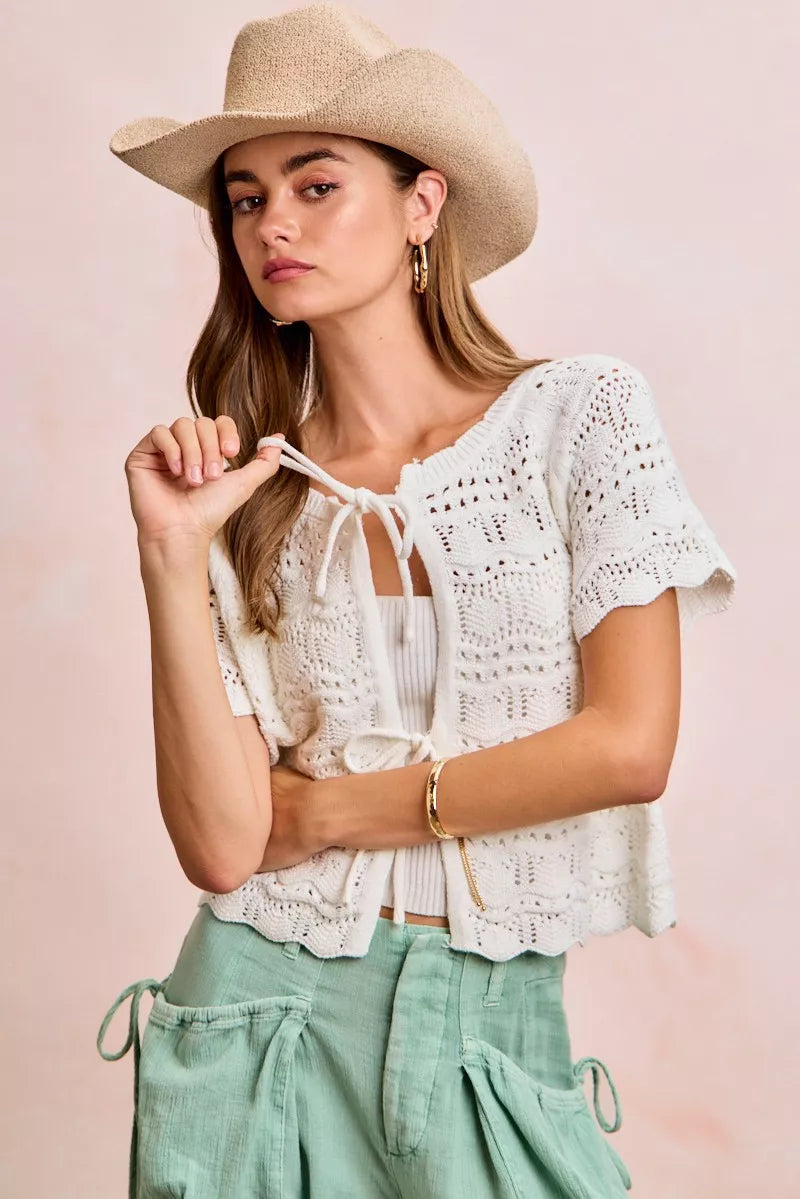 Ivory BiBi front bow tie detail pointelle knit top by Trendsi, showcasing a stylish knit fabric with a front bow accent.