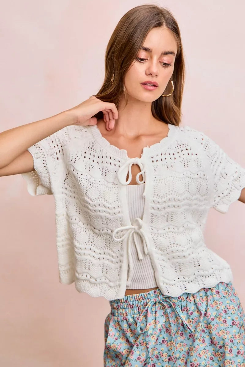 Ivory BiBi front bow tie detail pointelle knit top by Trendsi, showcasing a delicate bow and textured knit fabric.