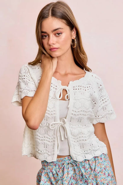 Ivory BiBi Front Bow Tie Detail Pointelle Knit Top by Trendsi, showing the delicate bow accent and intricate knit pattern.