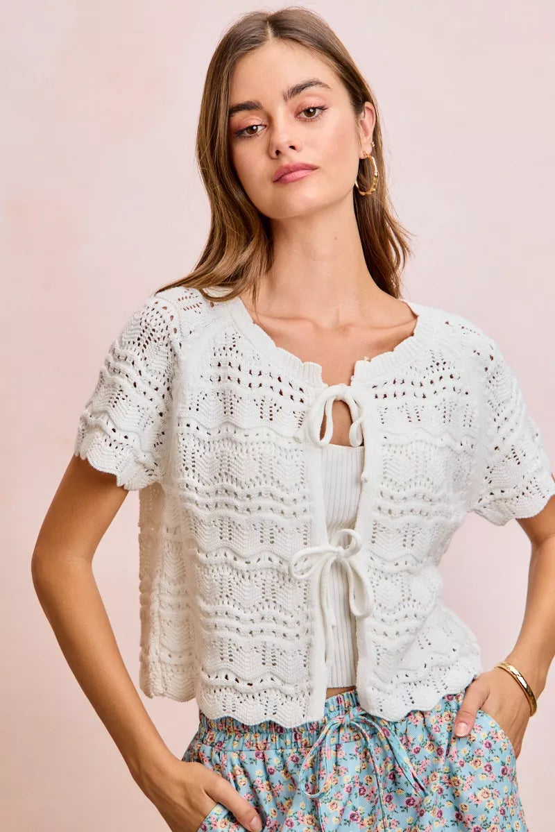 Ivory BiBi front bow tie detail pointelle knit top by Trendsi, showcasing the delicate knit pattern and bow accent.