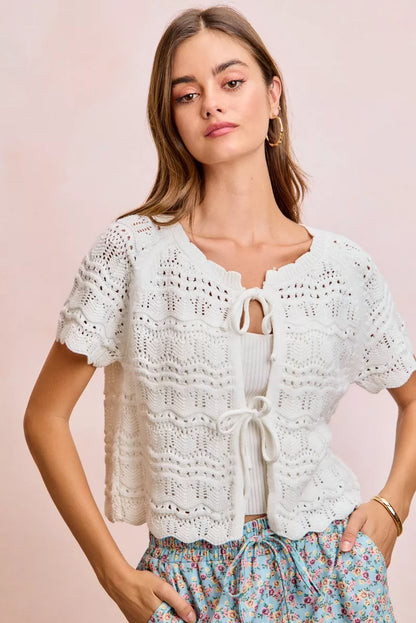 Ivory BiBi front bow tie detail pointelle knit top by Trendsi, showcasing the delicate knit pattern and bow accent.