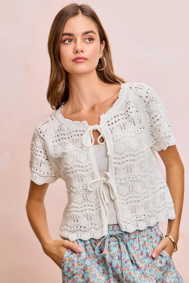 Ivory Trendsi BiBi front bow tie detail pointelle knit top, close-up of the lightweight, textured fabric with bow accent.