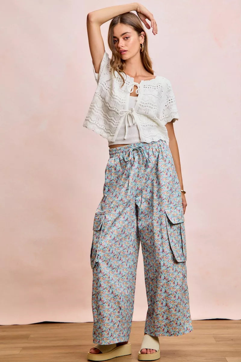 Ivory pointelle knit top by Trendsi with front bow tie detail, long sleeves, and a fitted, stylish design.