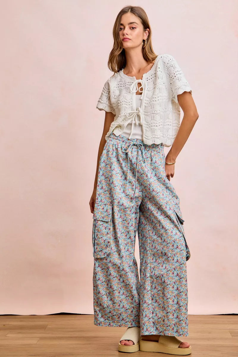 Ivory pointelle knit top by Trendsi with front bow tie detail and a fitted silhouette, perfect for casual or dressy occasions.