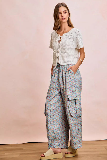 Ivory BiBi front bow tie detail pointelle knit top by Trendsi, showing the delicate knitted fabric and bow embellishment.