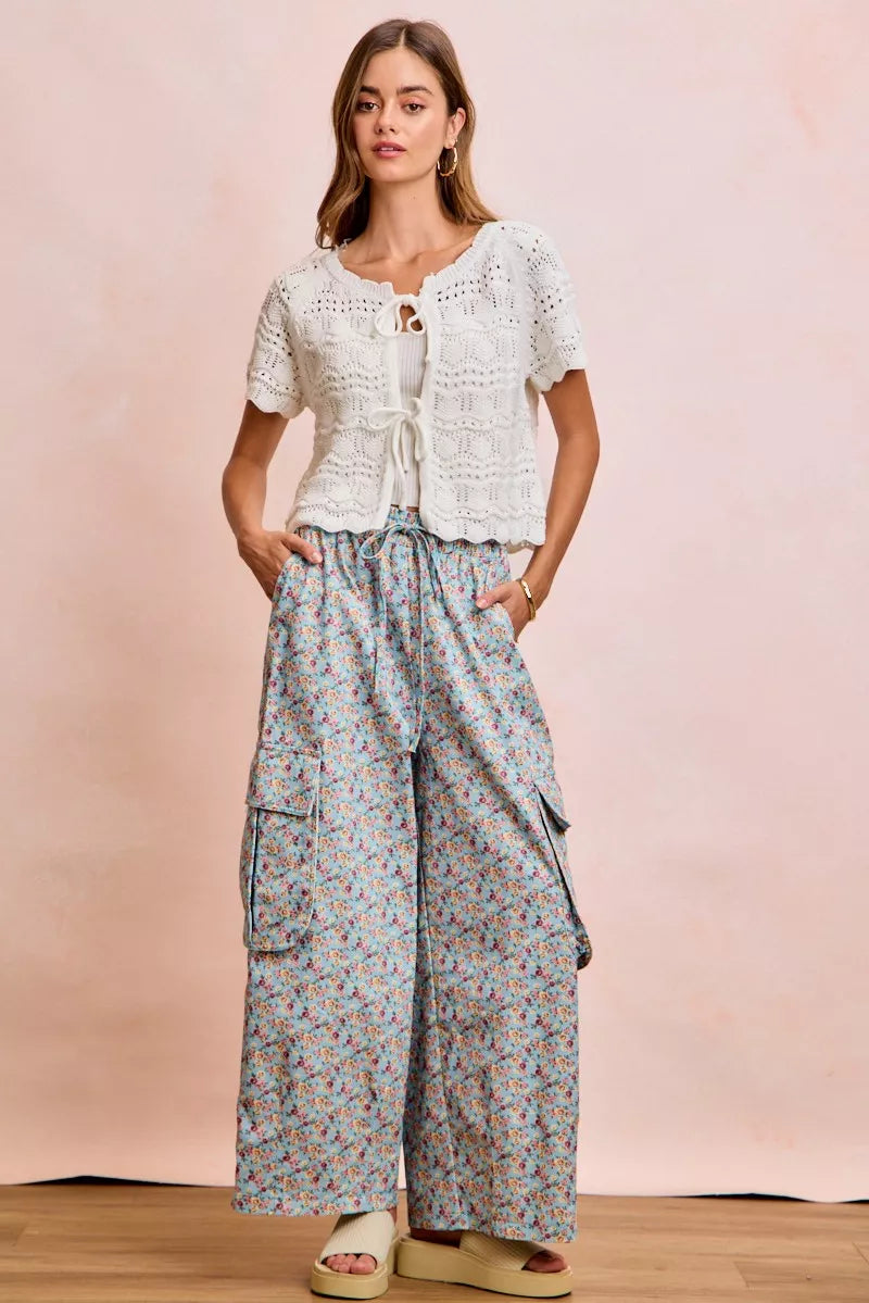 Ivory pointelle knit top by Trendsi with front bow tie detail and long sleeves, stylish and feminine for casual or dressy wear.