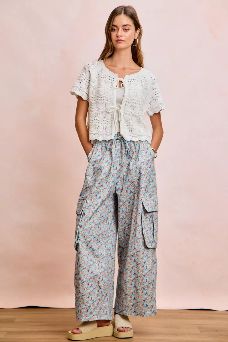 Ivory pointelle knit top by Trendsi featuring a front bow tie detail and a stylish, fitted design.