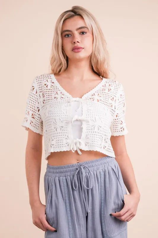 Ivory front tie crochet crop top by Trendsi featuring short sleeves and a fitted design, perfect for casual summer wear.