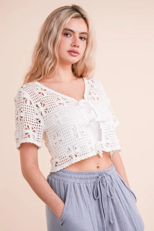 Ivory Very J crochet crop top with front tie from Trendsi, featuring a stylish, lightweight crochet design and short sleeves.
