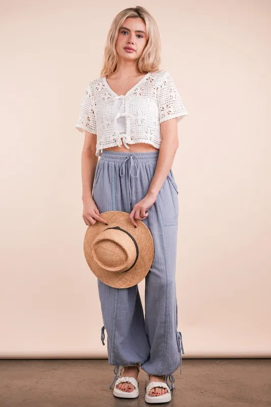 Ivory Very J front tie crochet crop top from Trendsi, featuring a stylish front tie and intricate crochet design.