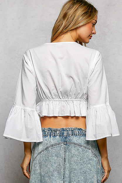 Ivory floral embroidered cropped blouse by Trendsi, featuring intricate embroidery and a stylish, casual fit.