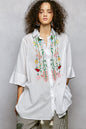 Ivory floral embroidered cotton half-sleeve shirt by Trendsi, showcasing intricate embroidery and lightweight fabric.