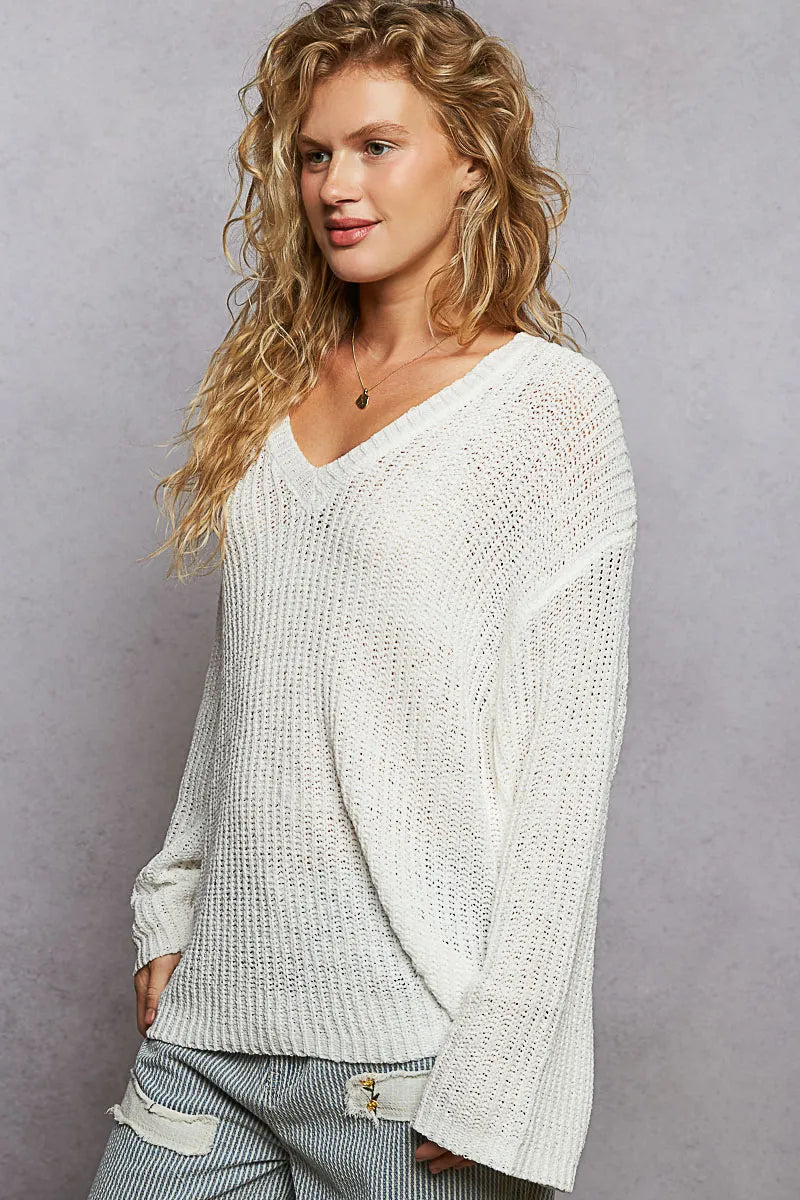 Ivory oversized V-neck knit top by Trendsi, featuring a relaxed fit and soft knit fabric, perfect for casual wear.