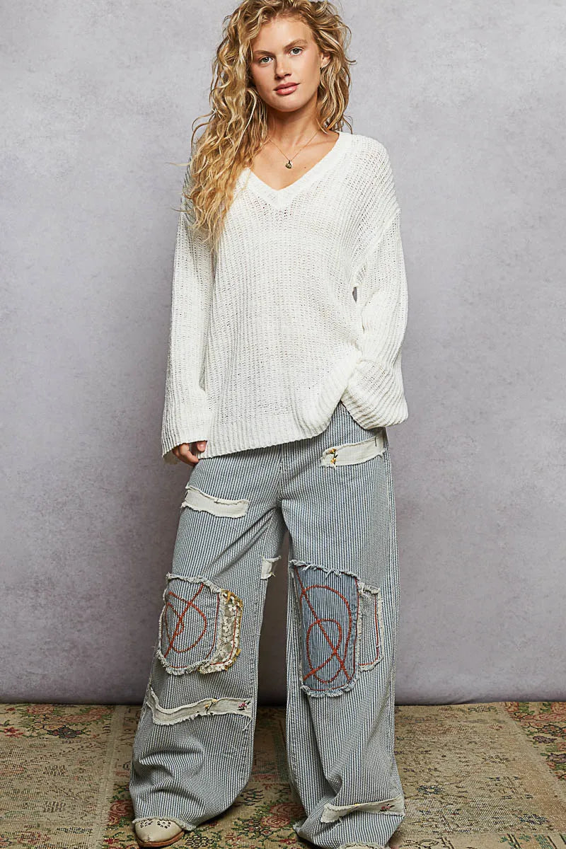 Ivory oversized V-neck knit top by Trendsi, featuring a relaxed fit and soft fabric, perfect for casual or layered looks.