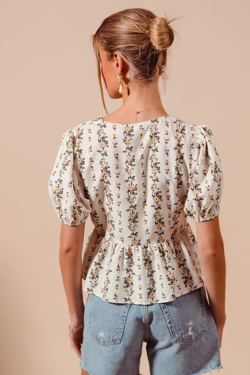 Ivory floral print tie-front blouse by Trendsi with shirred hem and long sleeves, perfect for casual or dressy occasions.