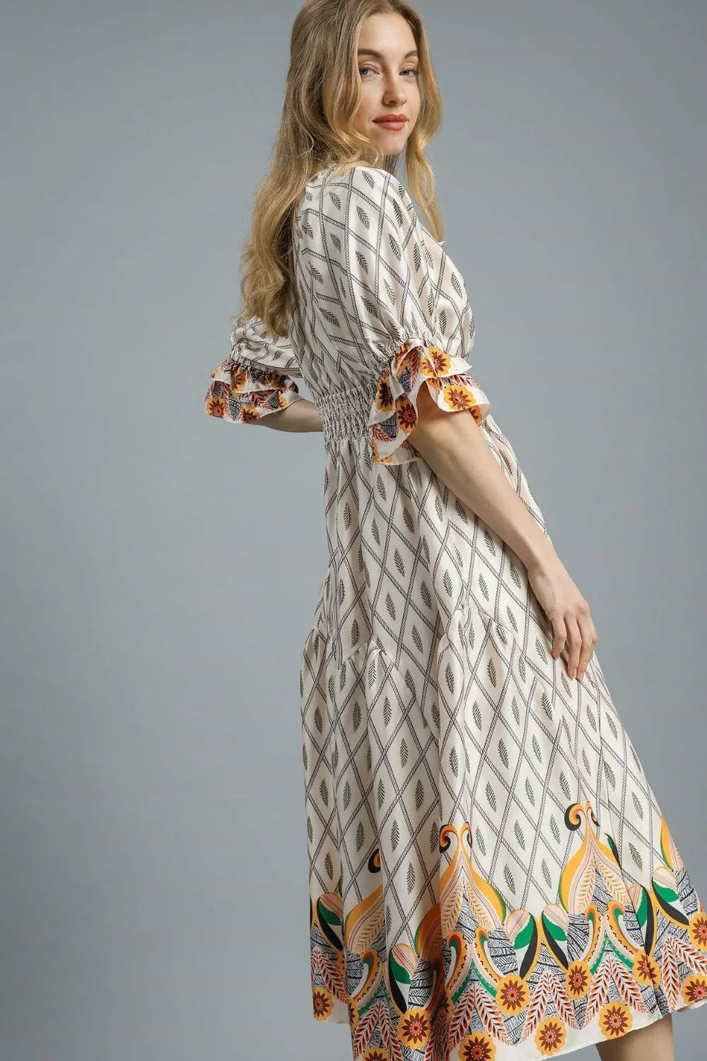 Ivory Umgee printed midi dress with smocked waist and flounce sleeves, stylish and comfortable for casual or dressy occasions.