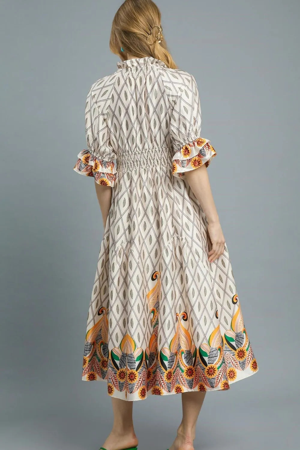 Ivory Umgee printed midi dress with smocked waist and flounce sleeves, stylish and comfortable for casual or dressy occasions.