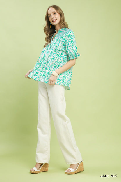 Trendsi Umgee Mix Boho Puff Sleeve Smocked Top with ruffled sleeves and relaxed fit, shown in a casual outdoor setting.