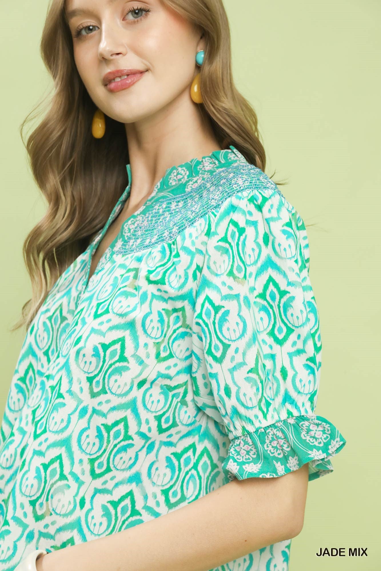 Trendsi Umgee Mix boho puff sleeve smocked top in jade with ruffled neckline and relaxed fit, styled on a model.