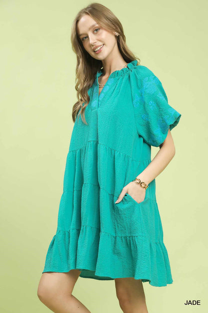 Umgee embroidered tiered mini dress with puff sleeves, featuring intricate embroidery and a stylish, feminine silhouette.