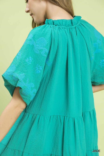 Umgee embroidered tiered mini dress with puff sleeves, featuring intricate embroidery and a stylish, feminine design.