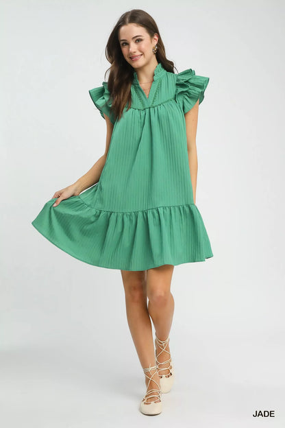 Umgee Flutter Sleeve Tiered Dress by Trendsi featuring a flowing silhouette, tiered fabric layers, and flutter sleeves in a stylish design.