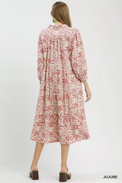 Umgee linen botanical print tiered midi dress with adjustable straps and flowy silhouette on a model.