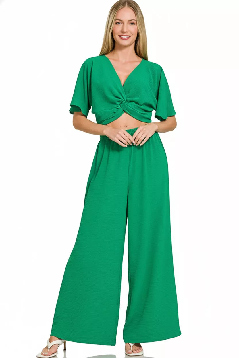Green Zenana woven airflow twisted top and wide-leg pants set from Trendsi, featuring a stylish twisted design and comfortable fit.