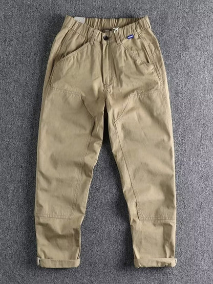 Men's plus size casual cargo pants with elastic waistband in khaki, from Trendsi, featuring multiple pockets and relaxed fit.