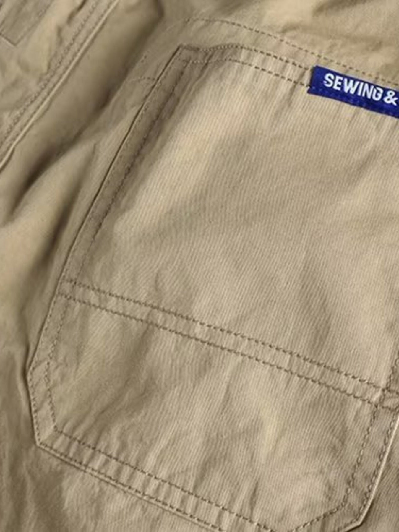 Men's plus size khaki cargo pants with elastic waist, casual style, from Trendsi, featuring multiple pockets and comfortable fit.