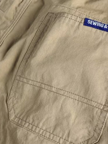 Men's plus size khaki cargo pants with elastic waist, casual style, from Trendsi, featuring multiple pockets and comfortable fit.