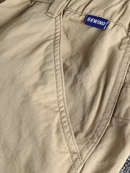 Men's plus size casual cargo pants with elastic waist in khaki, featuring multiple pockets and comfortable fit from Trendsi.