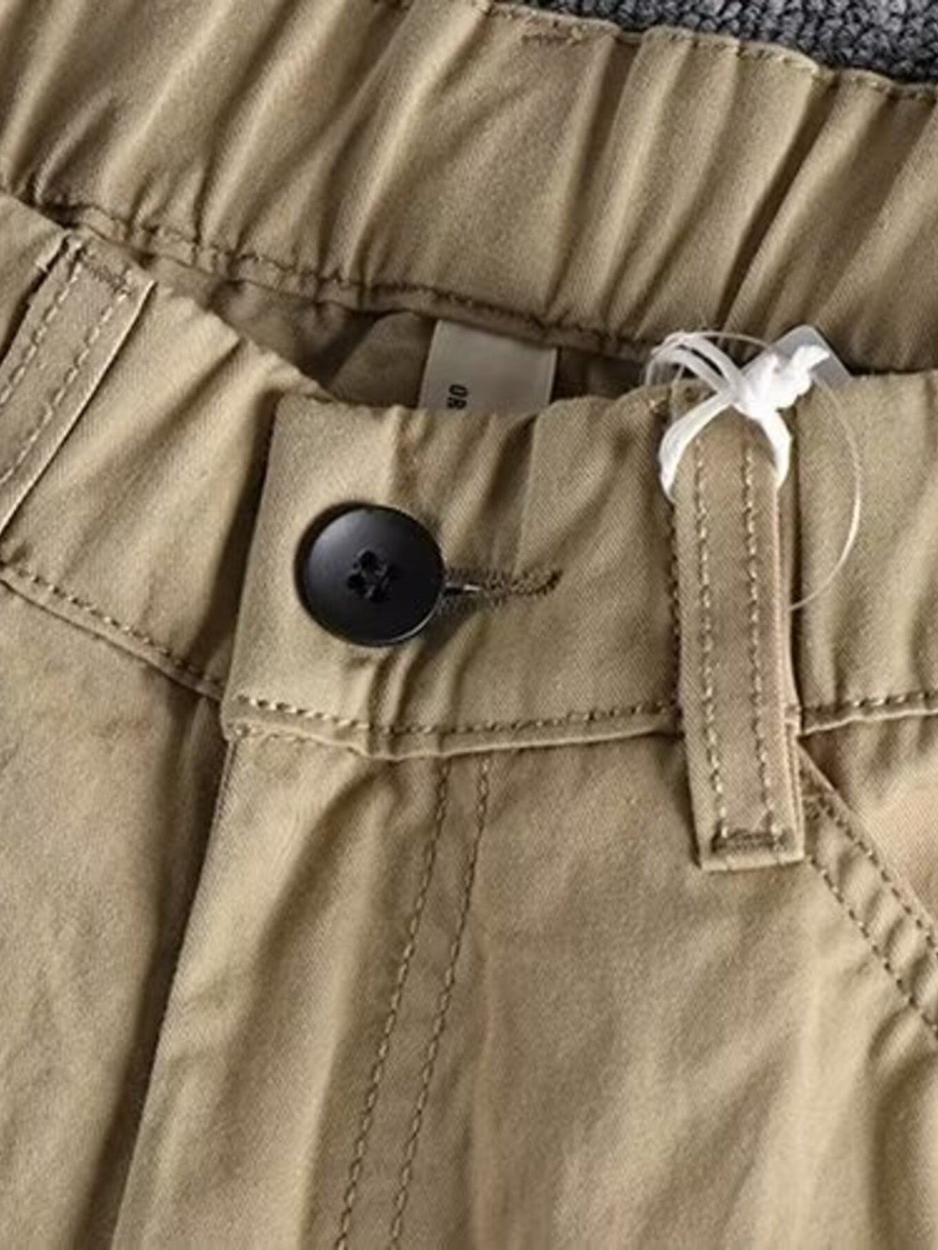 Men's plus size casual cargo pants with elastic waist in khaki, featuring multiple pockets, from Trendsi.
