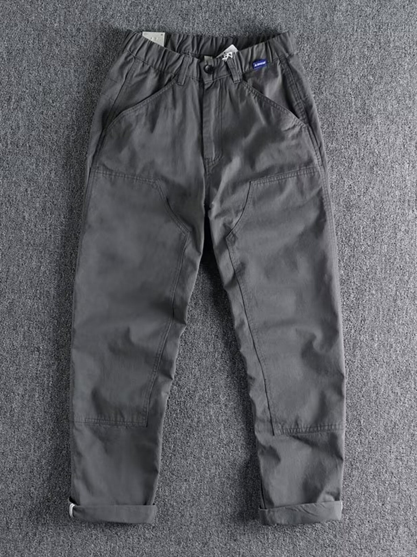 Men's plus size casual cargo pants with elastic waist in khaki, featuring multiple pockets and comfortable fit by Trendsi.