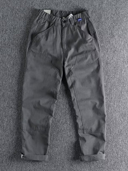Men's plus size casual cargo pants with elastic waist in khaki, featuring multiple pockets and comfortable fit by Trendsi.