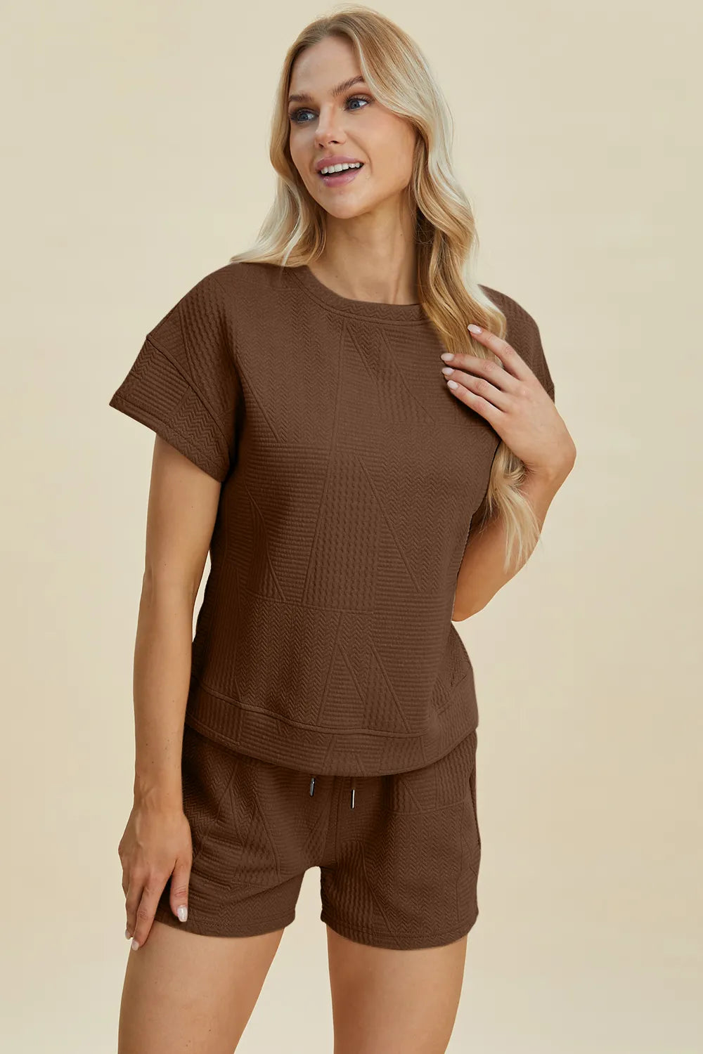 Khaki Trendsi Double Take full-size texture short sleeve top and matching shorts set laid flat.