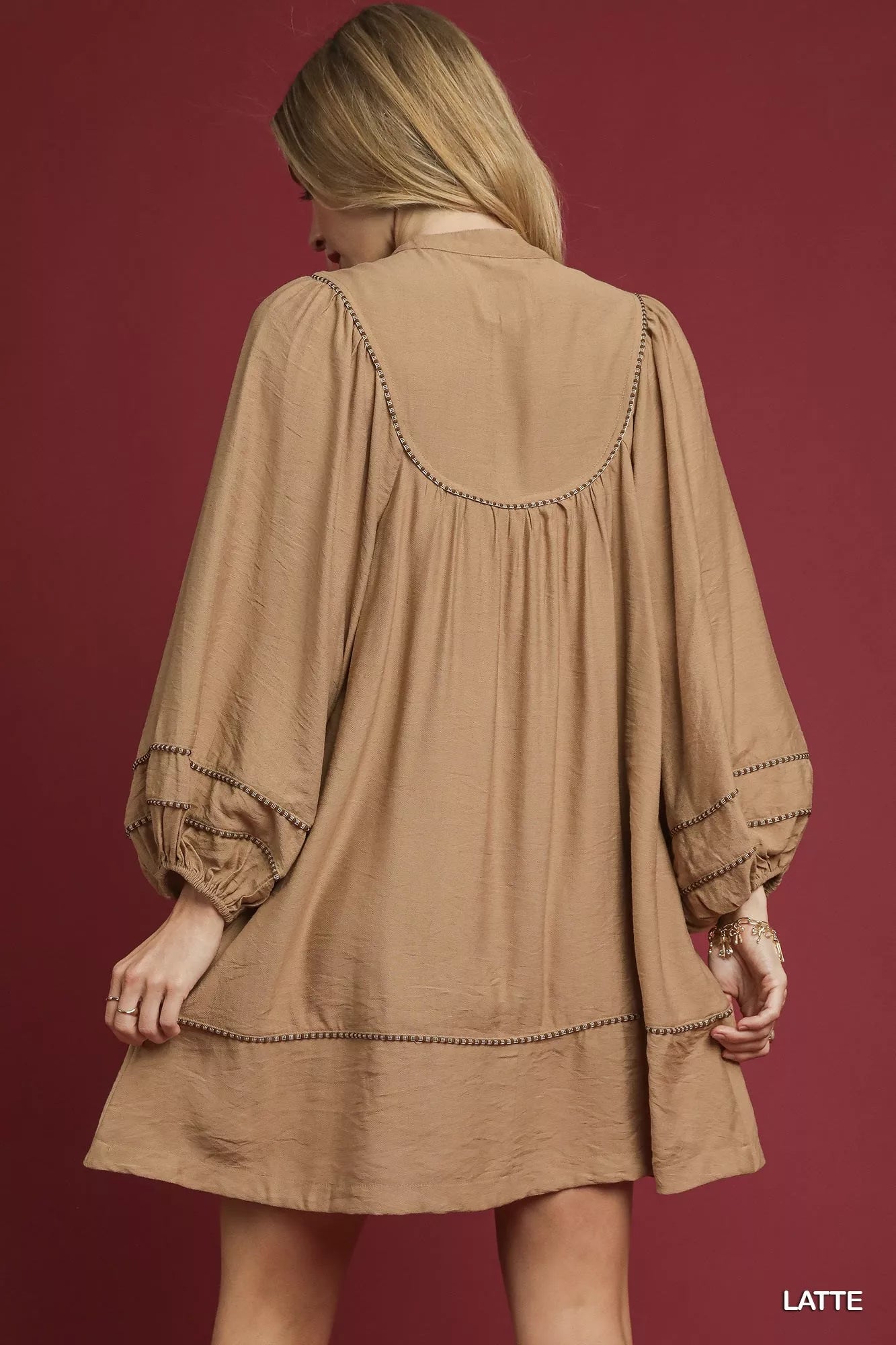 Umgee boho peasant mini dress with trim detail, featuring a relaxed fit and bohemian style, in a latte color.