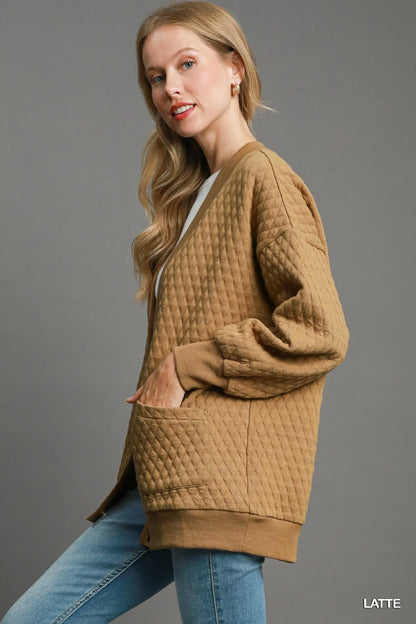 Light latte-colored Umgee button-up jacquard cardigan with intricate woven pattern, styled for a cozy, fashionable look.
