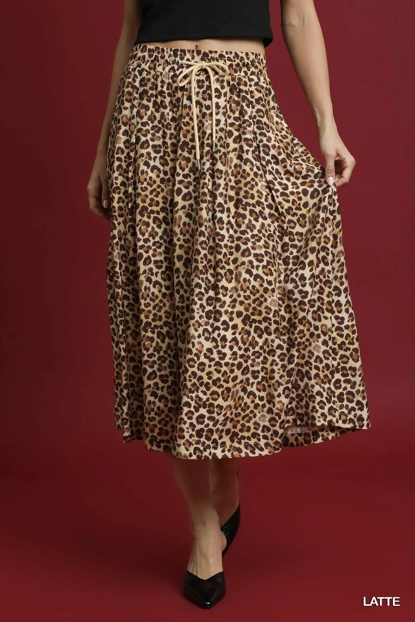 Umgee leopard midi skirt with drawstring waist, featuring a stylish leopard print and flowy silhouette.