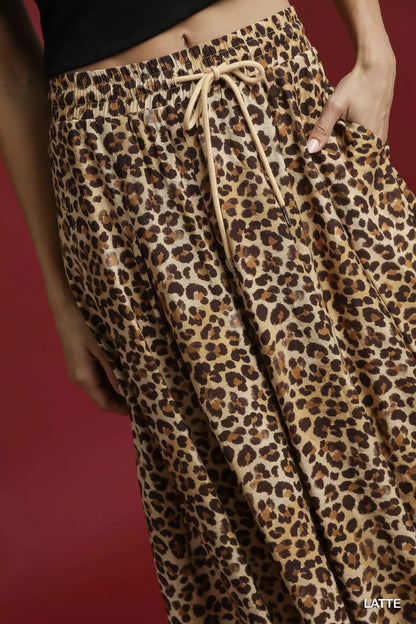 Umgee leopard midi skirt with drawstring waist, featuring a stylish animal print and flowy silhouette.