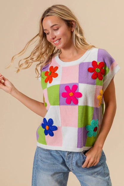 Lavender blush and lime checkered sweater vest with Bibi flower patch detail from Trendsi, cozy and stylish for casual wear.