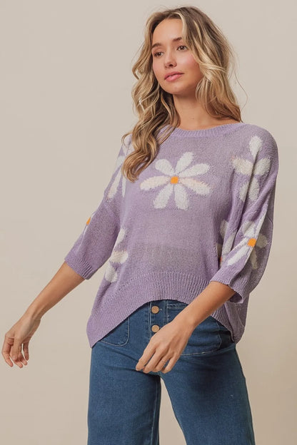 Lavender and ivory BiBi floral pattern slit sweater by Trendsi, showcasing a stylish knit with floral accents and a front slit detail.